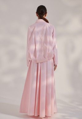 A long-Sleeve Bomber Jacket Paired With A Flowy Skirt